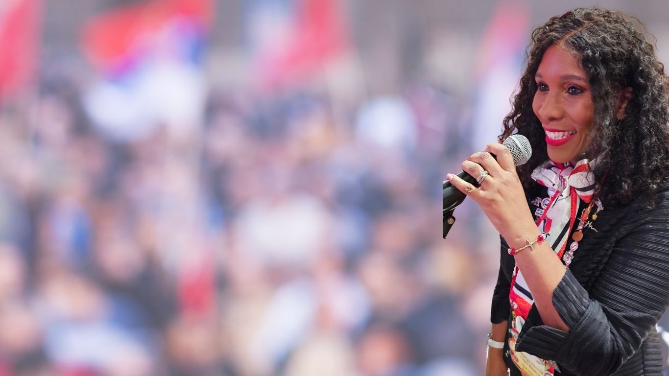 Pastor Jearlyn Dennie with Microhpone Background